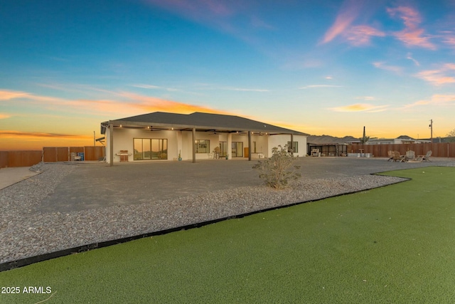 35150 N Bell Rd, Queen Creek, AZ 85144 - back of house at dusk featuring a fenced backyard, a patio area, and ceiling fan