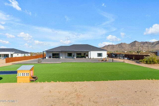 35150 N Bell Rd, Queen Creek, AZ 85144 - rear view of house with a lawn, a mountain view, an outdoor structure, and fence