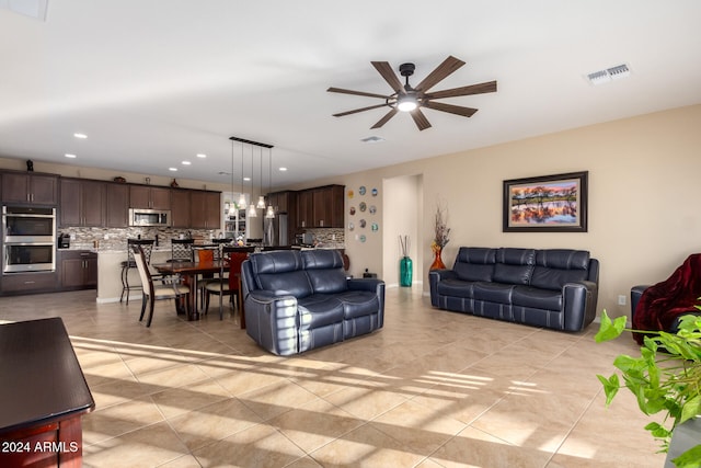 living room featuring light tile patterned floors and ceiling fan