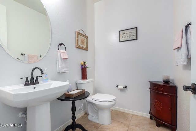 bathroom with tile patterned flooring and toilet