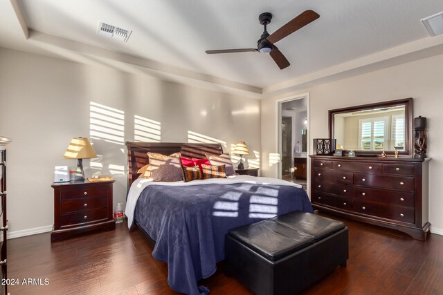 bedroom featuring connected bathroom, ceiling fan, and dark wood-type flooring