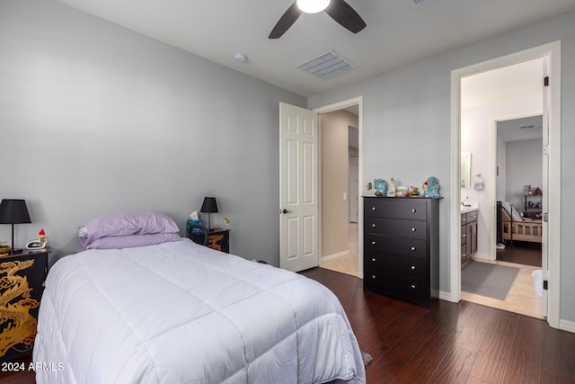 bedroom with connected bathroom, ceiling fan, and dark wood-type flooring