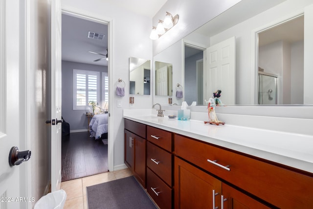 bathroom with ceiling fan, wood-type flooring, a shower with door, and vanity