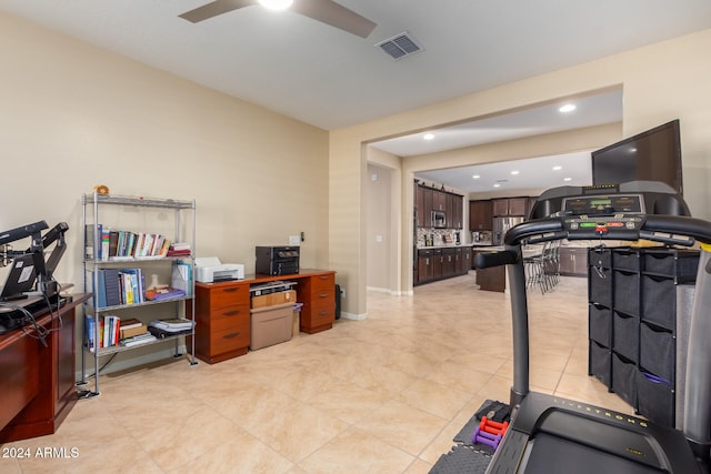 exercise room with ceiling fan