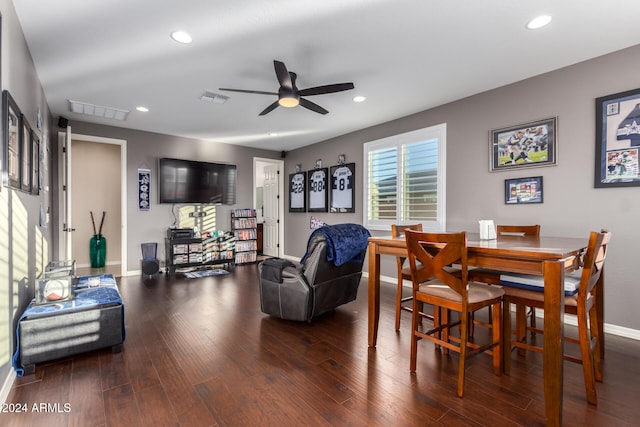 dining space with ceiling fan and dark wood-type flooring