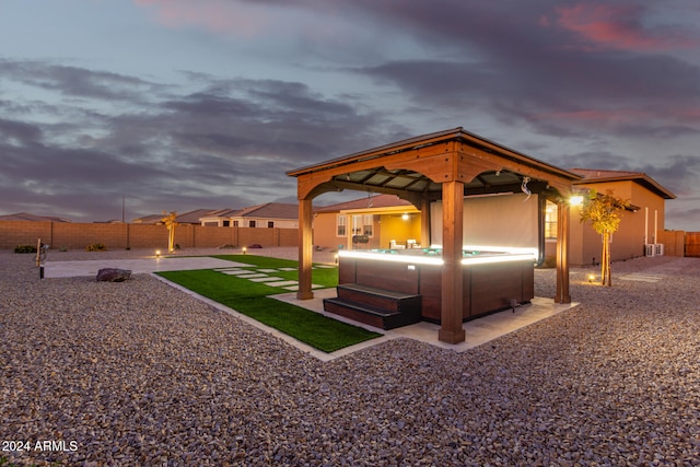 exterior space with a gazebo and a hot tub