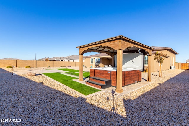 view of yard featuring a gazebo, a hot tub, and a patio area