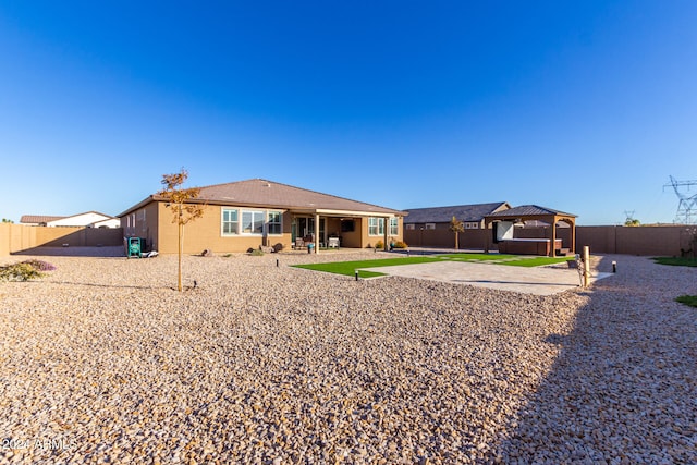 rear view of house with a gazebo and a patio area