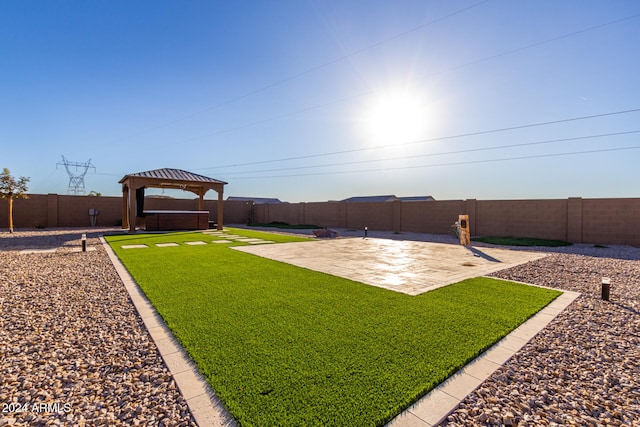 view of yard with a gazebo, a patio area, and a hot tub