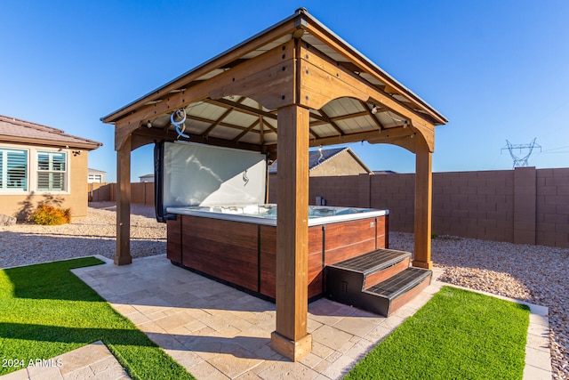 view of patio featuring a gazebo and a hot tub