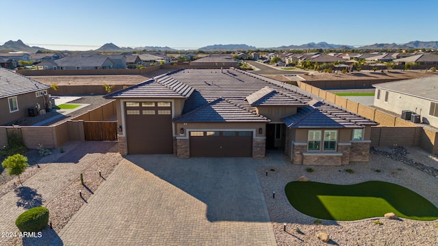 view of front facade featuring a mountain view and a garage