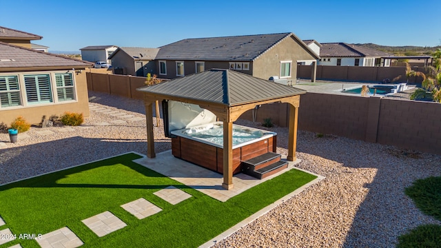 view of yard featuring a gazebo, a patio area, and a swimming pool with hot tub