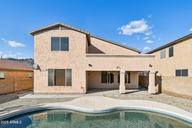 1801 W Nighthawk Way, Phoenix, AZ 85045 - back of house featuring a fenced backyard, a patio area, and stucco siding