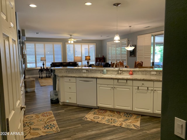 kitchen featuring white cabinets, sink, dark hardwood / wood-style floors, ceiling fan, and light stone counters