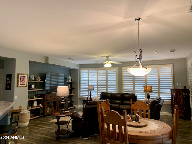 dining space with dark hardwood / wood-style floors and ceiling fan