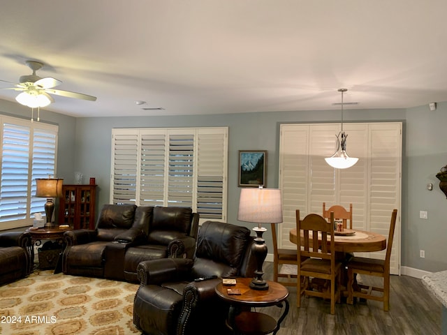 living room featuring hardwood / wood-style floors and ceiling fan