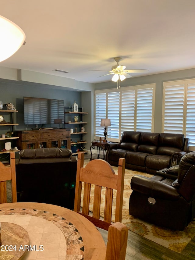 living room with ceiling fan and wood-type flooring