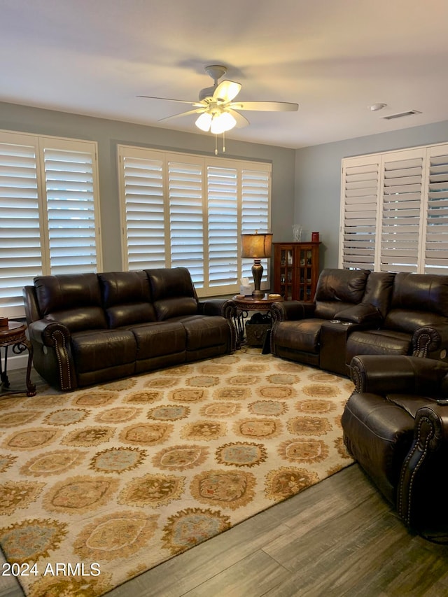 living room featuring ceiling fan and wood-type flooring