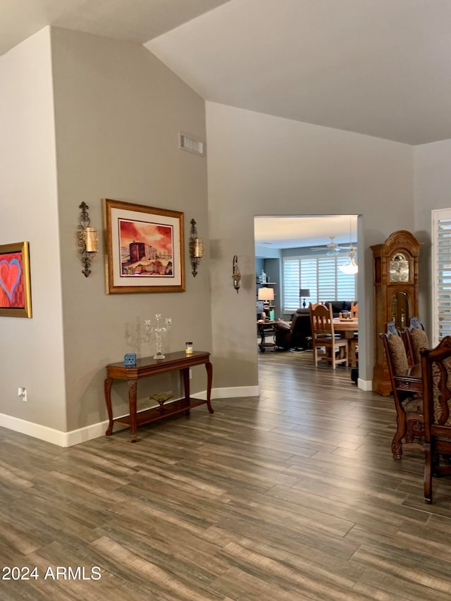 interior space featuring ceiling fan, dark hardwood / wood-style flooring, and lofted ceiling