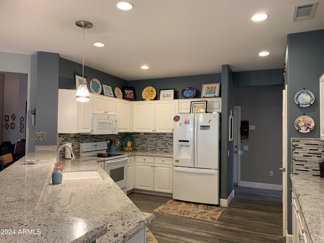 kitchen with dark hardwood / wood-style flooring, white appliances, sink, white cabinetry, and hanging light fixtures