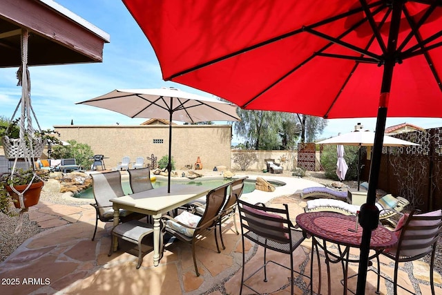 view of patio / terrace featuring a fenced in pool, outdoor dining area, and a fenced backyard