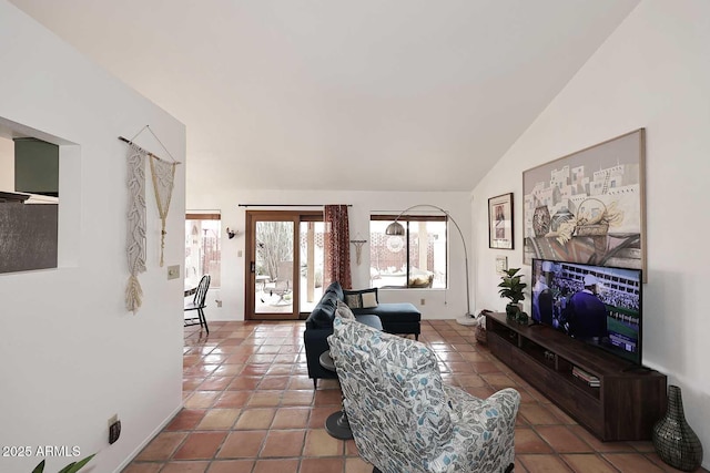 tiled living area with lofted ceiling