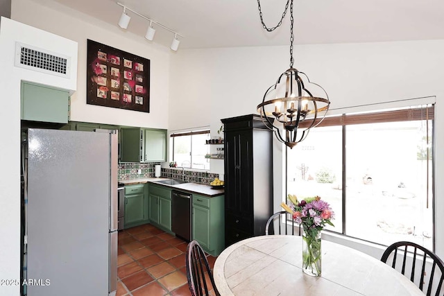 kitchen featuring visible vents, a sink, stainless steel appliances, an inviting chandelier, and green cabinets