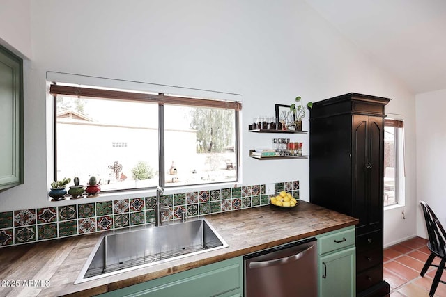 kitchen featuring green cabinets, butcher block countertops, stainless steel dishwasher, and a sink