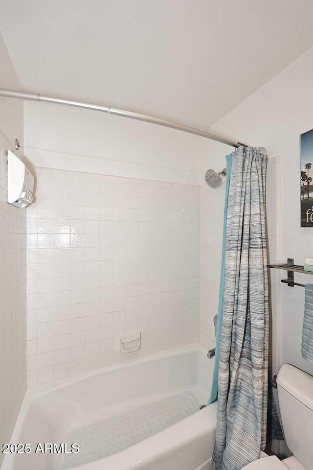 bathroom featuring shower / tub combo with curtain and toilet