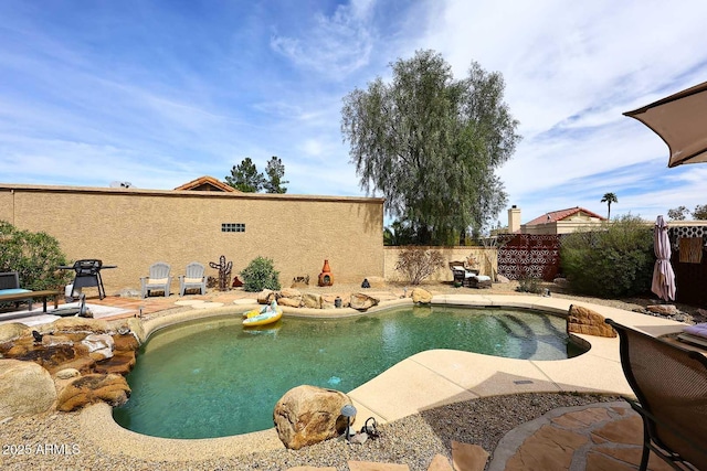 view of pool featuring a fenced in pool, a grill, a fenced backyard, and a patio area