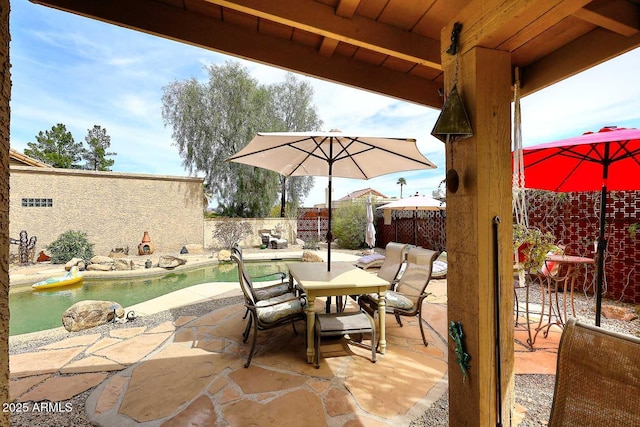 view of patio / terrace with a fenced in pool, outdoor dining area, and a fenced backyard