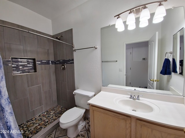 bathroom featuring a shower with shower curtain, vanity, and toilet