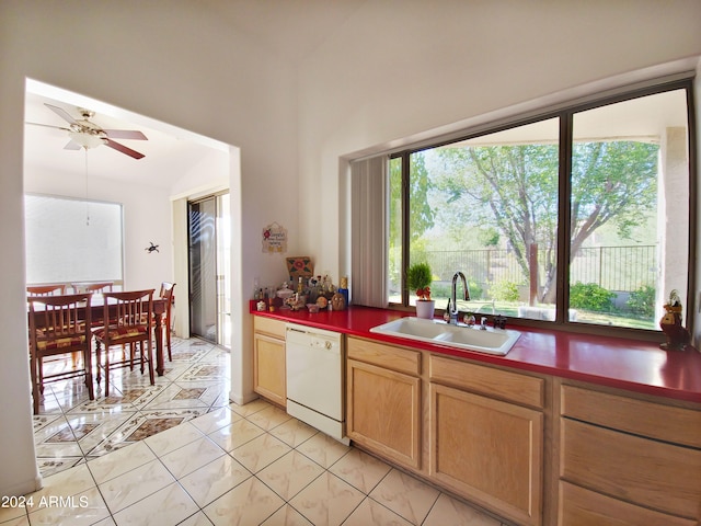 kitchen featuring ceiling fan, white dishwasher, lofted ceiling, light tile patterned floors, and sink