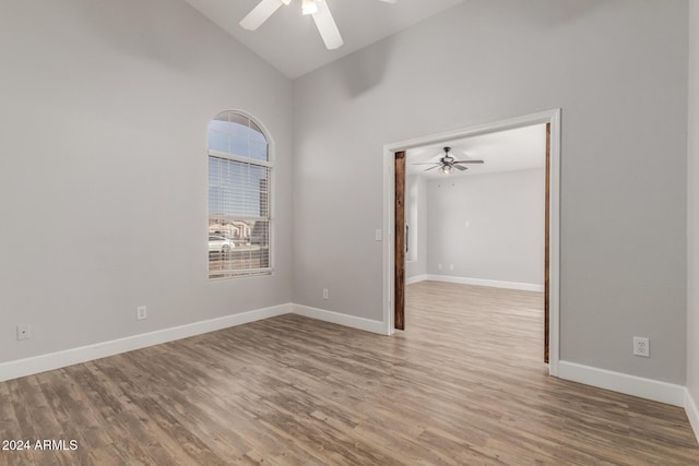 unfurnished room featuring hardwood / wood-style flooring, a healthy amount of sunlight, and high vaulted ceiling