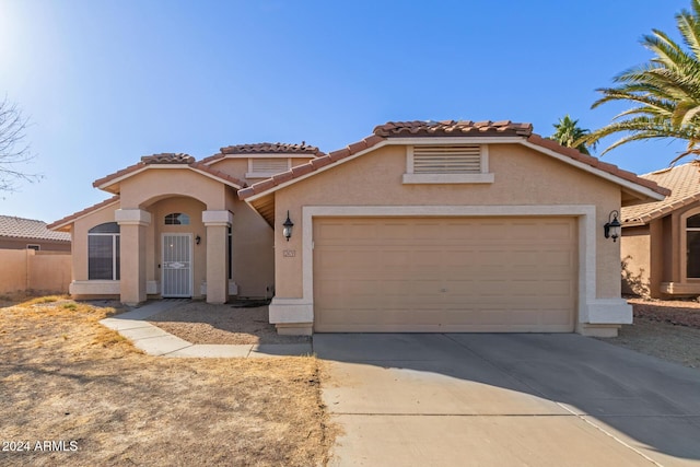 mediterranean / spanish-style house featuring a garage