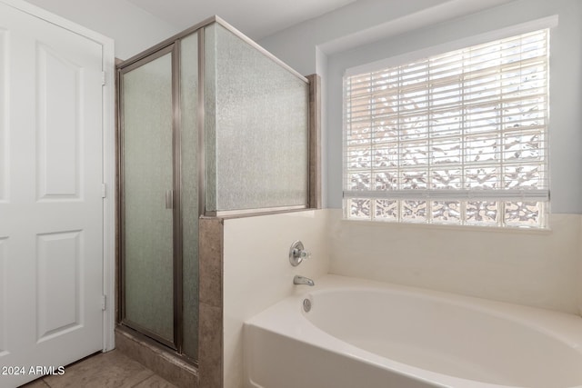 bathroom with plenty of natural light and separate shower and tub