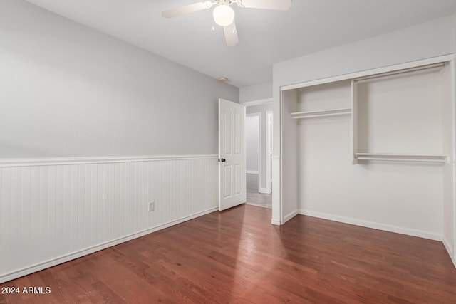 unfurnished bedroom with ceiling fan, a closet, and dark hardwood / wood-style floors