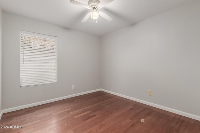 empty room with hardwood / wood-style floors and ceiling fan