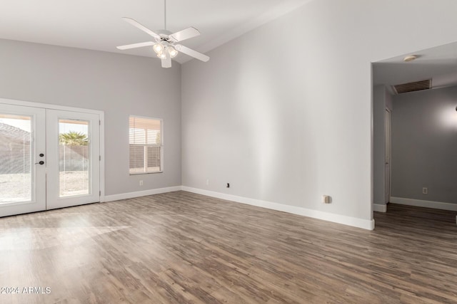 spare room with ceiling fan, french doors, high vaulted ceiling, and dark wood-type flooring