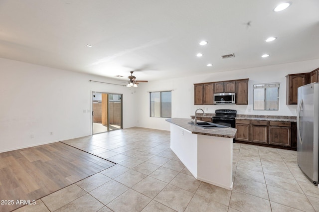 11669 N 165th Ave, Surprise, AZ 85388 - kitchen with open floor plan, light tile patterned floors, recessed lighting, appliances with stainless steel finishes, and a sink