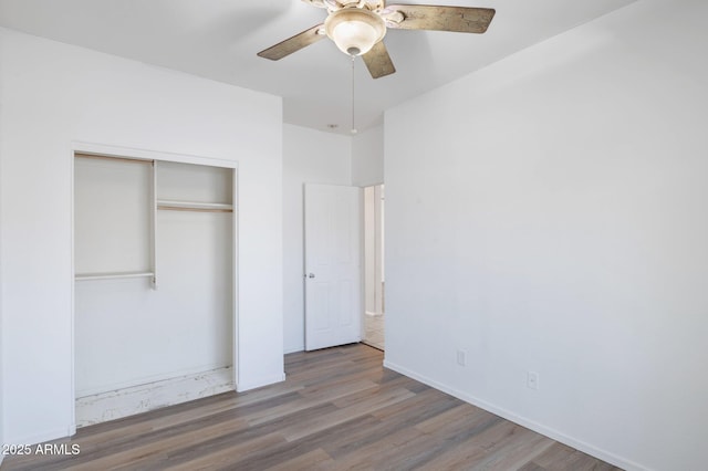 11669 N 165th Ave, Surprise, AZ 85388 - unfurnished bedroom featuring a closet, baseboards, wood finished floors, and a ceiling fan