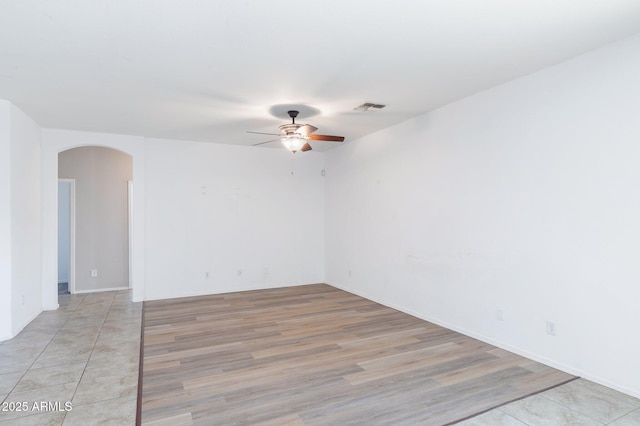 11669 N 165th Ave, Surprise, AZ 85388 - spare room with light wood-type flooring, arched walkways, visible vents, and ceiling fan
