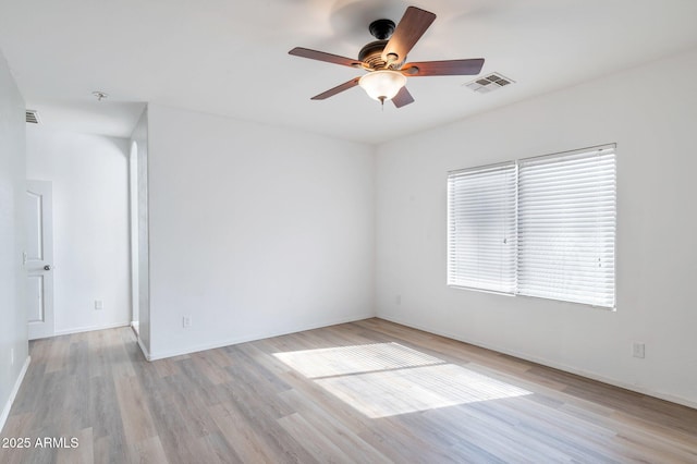 11669 N 165th Ave, Surprise, AZ 85388 - empty room featuring visible vents, baseboards, ceiling fan, and wood finished floors