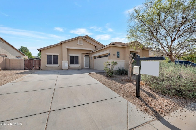 11669 N 165th Ave, Surprise, AZ 85388 - view of front of property featuring stucco siding, a gate, fence, concrete driveway, and an attached garage