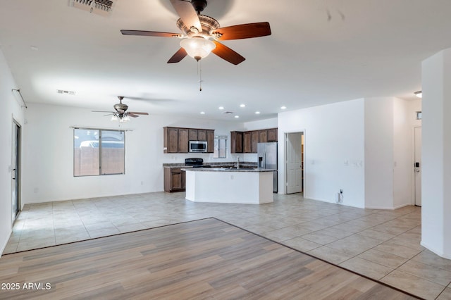 11669 N 165th Ave, Surprise, AZ 85388 - kitchen with open floor plan, appliances with stainless steel finishes, and visible vents