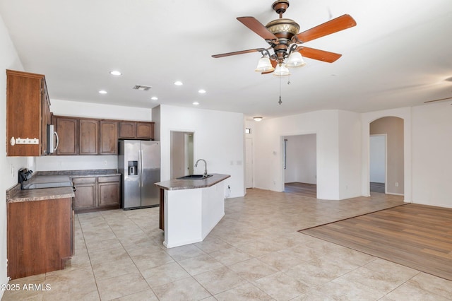 11669 N 165th Ave, Surprise, AZ 85388 - kitchen with a ceiling fan, a sink, open floor plan, stainless steel appliances, and arched walkways