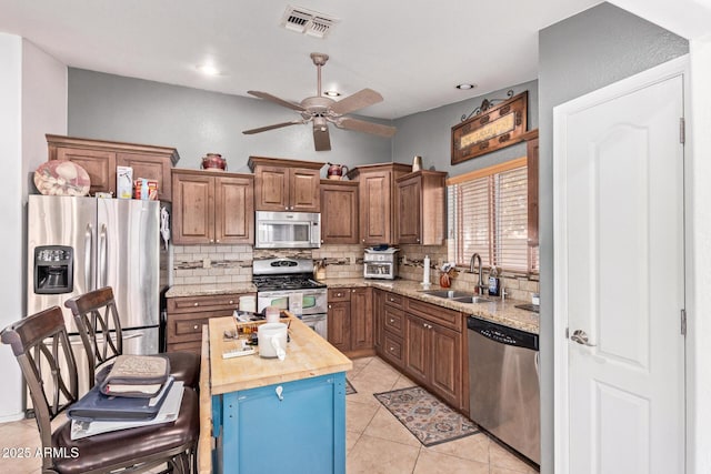 20769 N 106th Ln, Peoria, AZ 85382 - kitchen with stainless steel appliances, decorative backsplash, ceiling fan, light tile patterned flooring, and recessed lighting