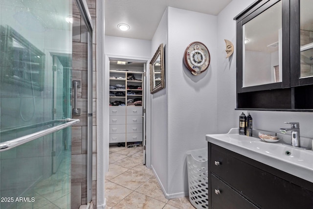 20769 N 106th Ln, Peoria, AZ 85382 - bathroom with a stall shower, a walk in closet, vanity, and tile patterned floors