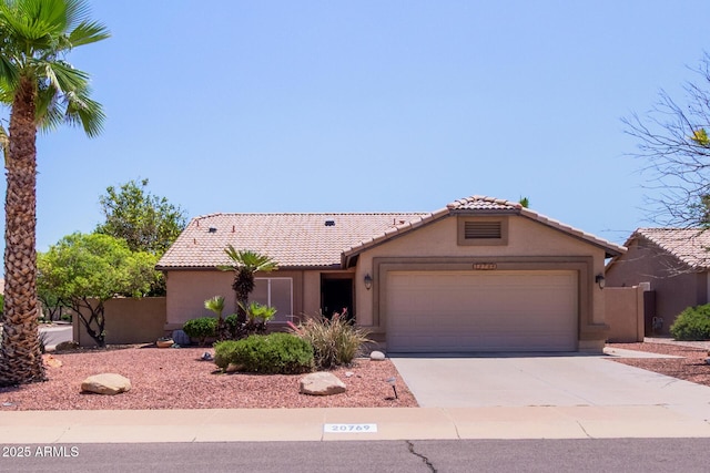 20769 N 106th Ln, Peoria, AZ 85382 - view of front of house with stucco siding, a garage, driveway, and a tile roof