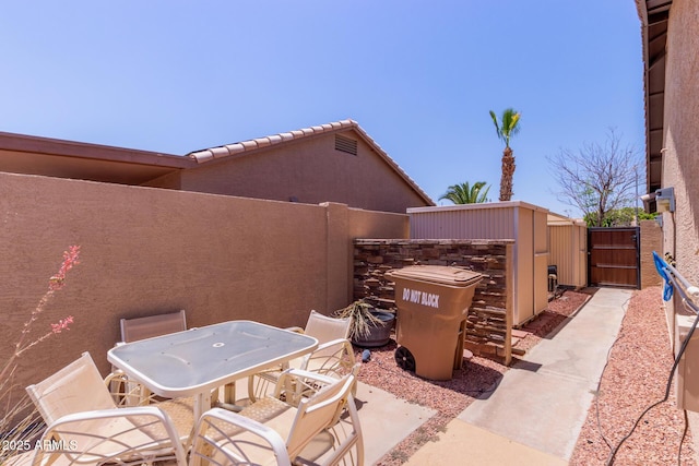 20769 N 106th Ln, Peoria, AZ 85382 - view of patio / terrace featuring a gate and outdoor dining area
